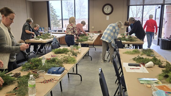 participants make a fresh greenery wreath